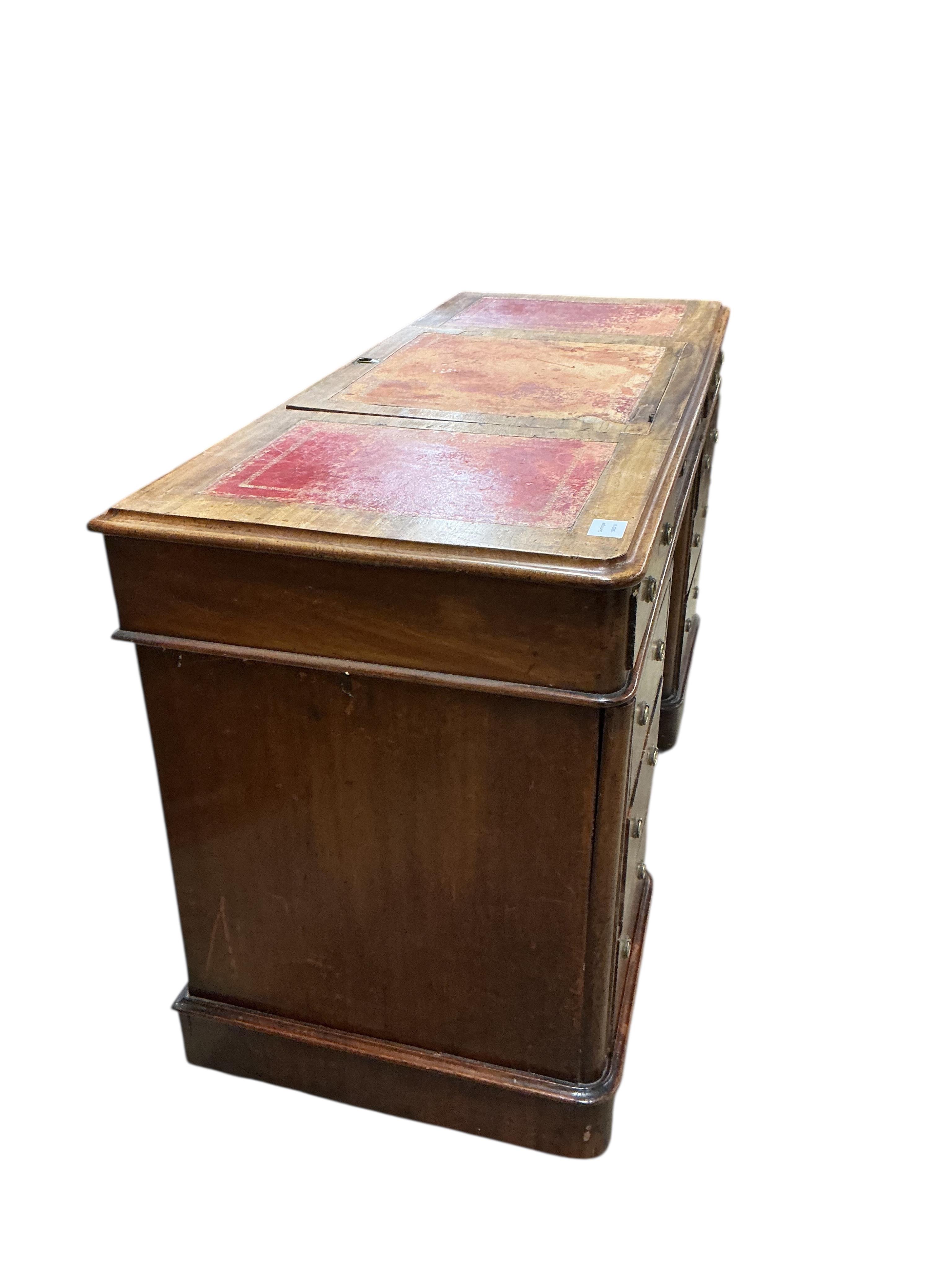 A Victorian mahogany pedestal desk, the top with hinged central section, width 122cm, depth 53cm, height 78cm
